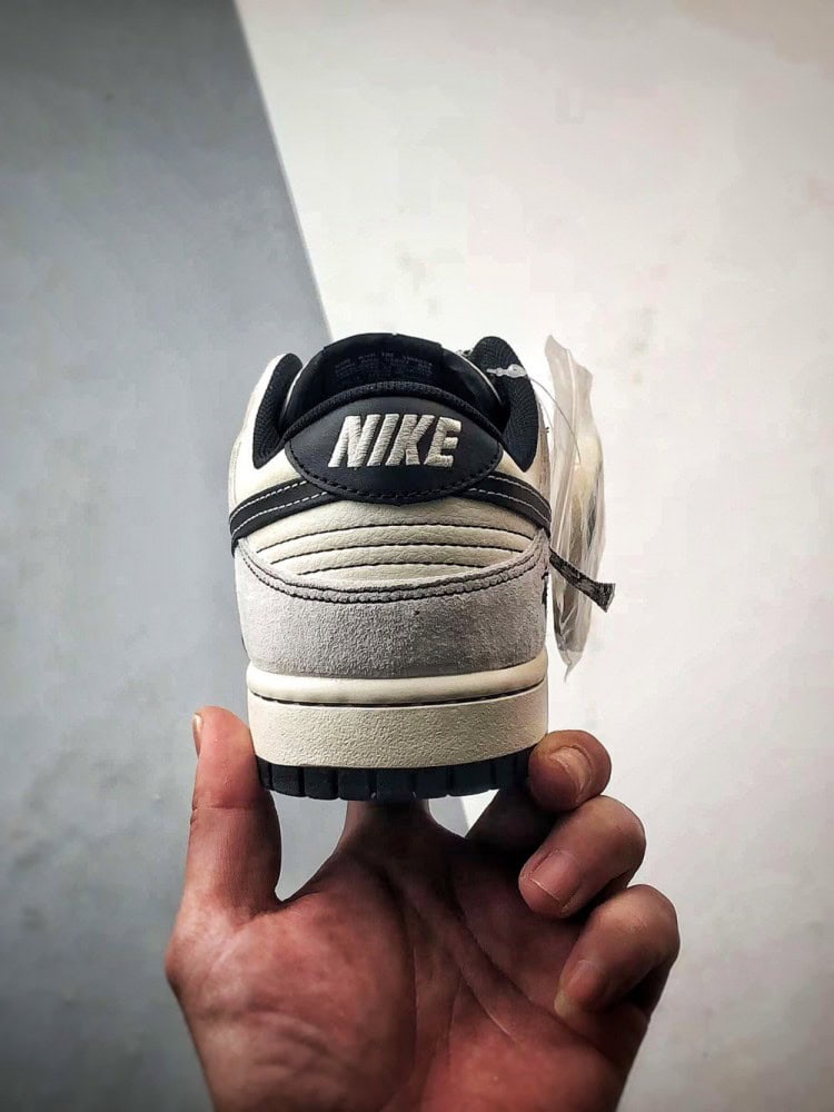 【AT3299】Nike Dunk x Stussyのコラボレーションクラシックスニーカー、Nike Dunk Low Retroが登場しました。Stussyの布製タグが付いたベージュと黒の低カットカジュアルスポーツシューズ。
