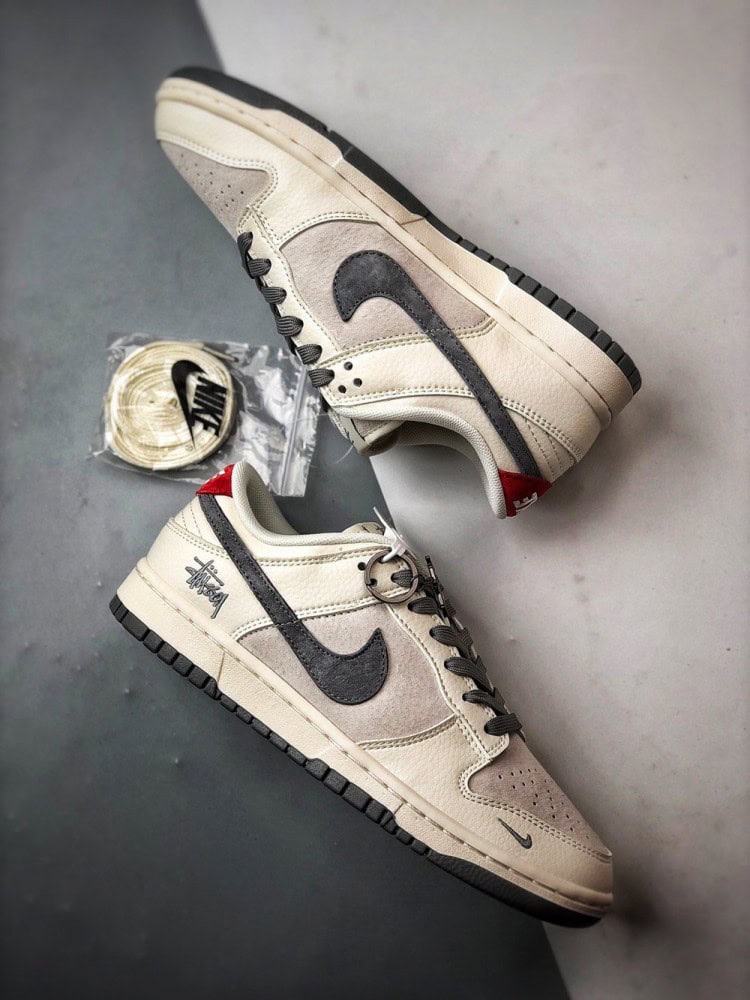 【AT3330】Nike x Stussy Dunk コラボレーションモデル、Nike Dunk Low Retro。ステューシーのグレーと赤いテールが印象的なローカットスポーツシューズ。
